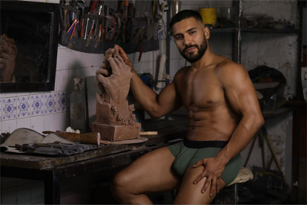 A clay sculpture hand in mid gesture shaped by artist hands with xtremen 91252 microfiber mesh trunks military green