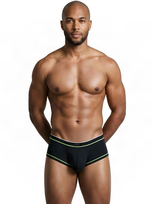 A shirtless man models black Xtremen athletic briefs with neon green trim against a white background.