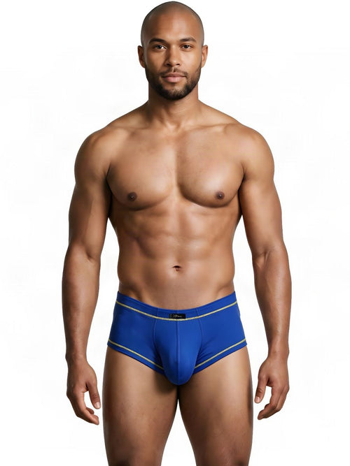 Man wearing royal blue athletic briefs with gold trim, standing against a white background.