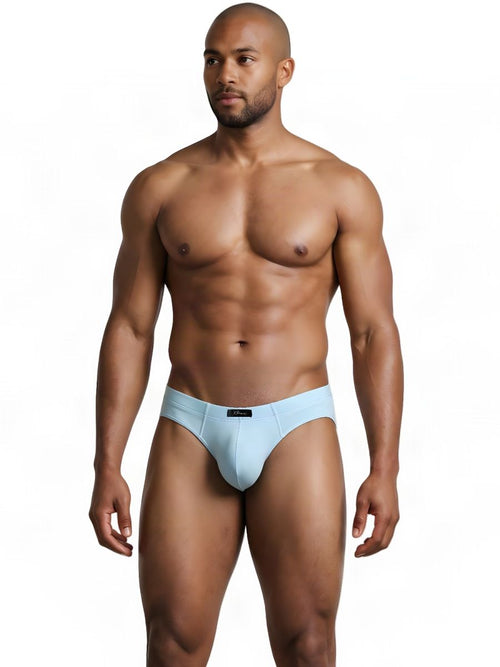 An athletic man models light blue Xtremen sleek fit briefs against a white background.