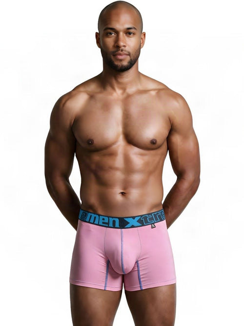 Muscular man wearing pink Xtremen microfiber boxer briefs with a branded waistband against a white background.
