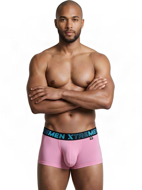 A muscular man poses with arms crossed, wearing pink Xtremen microfiber trunks with a black branded waistband.