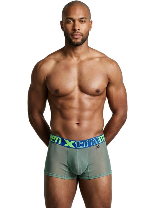An athletic man wearing green microfiber mesh boxer briefs with a blue branded waistband.