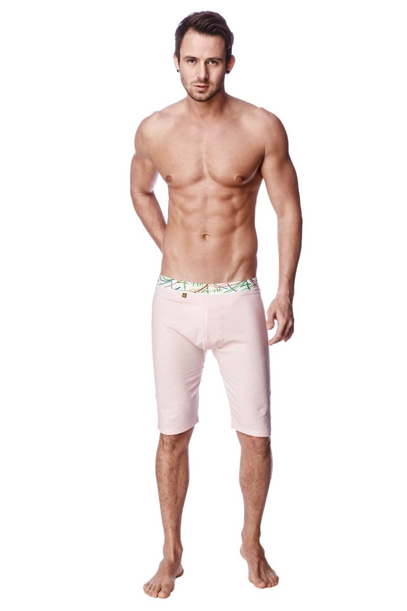 Pink yoga compression short with light pink form-fitting briefs and green and white patterned waistband