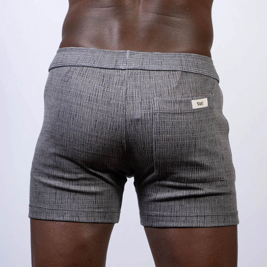 Gray abstract linen texture shorts with subtle herringbone pattern and white brand tag on back waistband visible