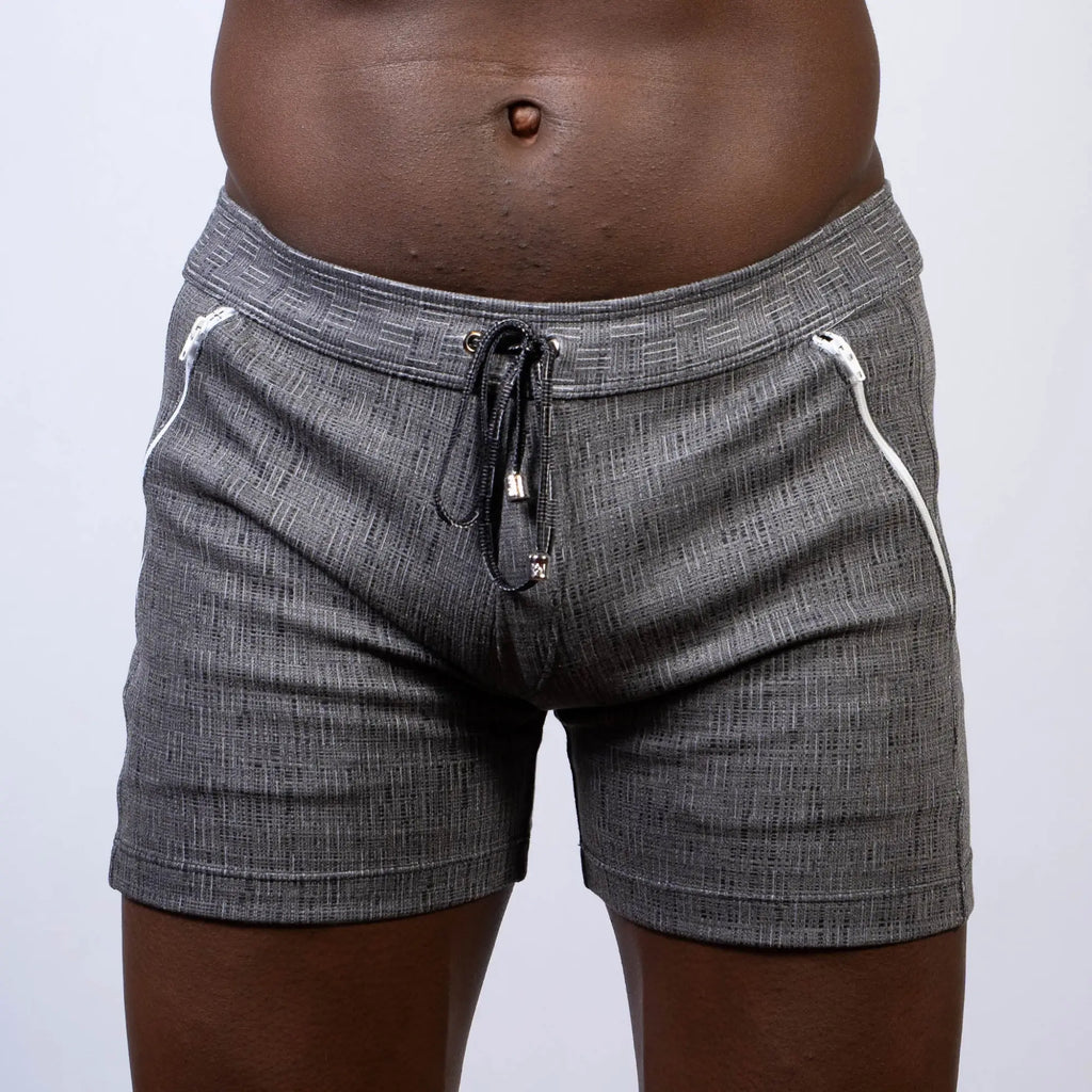 Abstract linen texture shorts in gray with textured fabric white zipper accents and black drawstring waistband