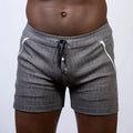 Abstract linen texture shorts in gray with textured fabric white zipper accents and black drawstring waistband
