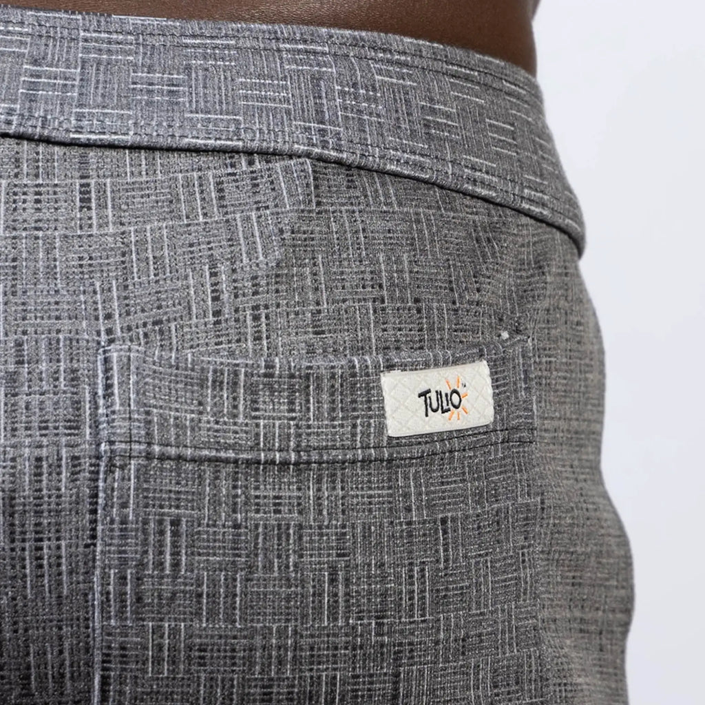 Gray woven linen texture shorts with a subtle geometric pattern and tulio label on the back pocket shown from the back