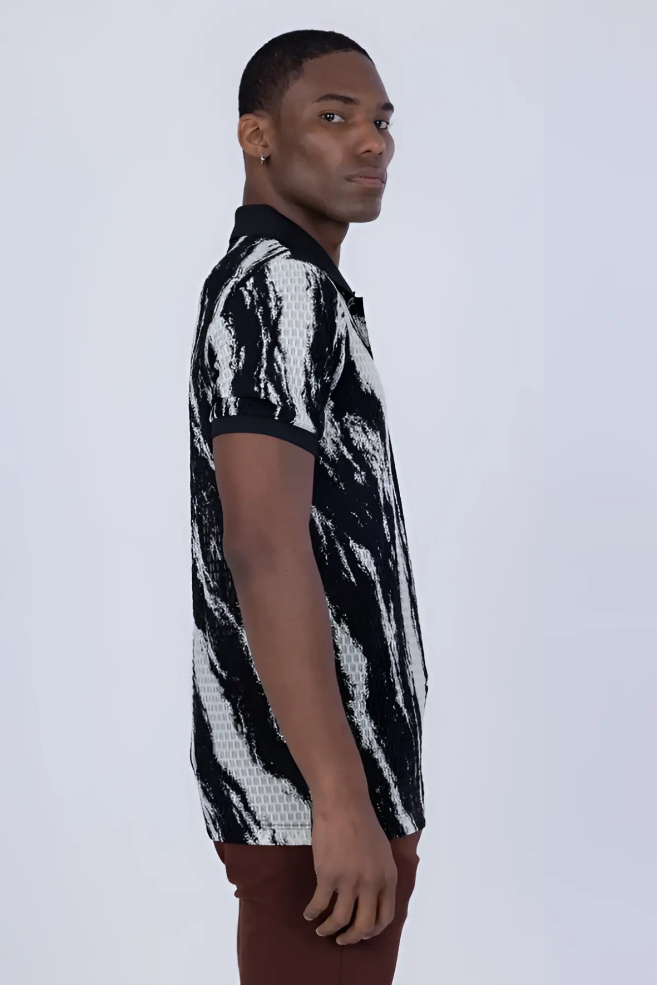 Black and white abstract patterned polo shirt with textured knit design for stylish casual wear