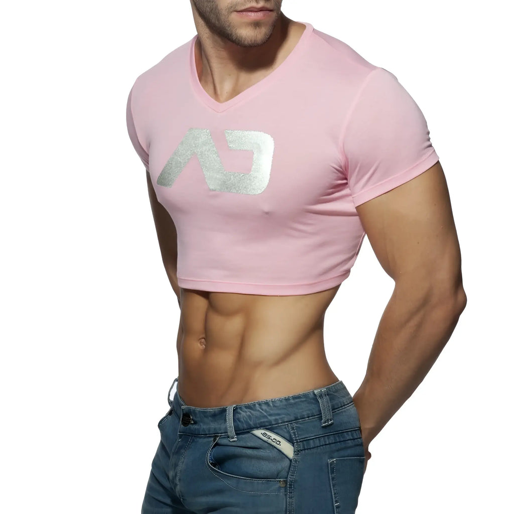 Pink cropped v-neck t-shirt with a silver metallic logo from ad crop top collection