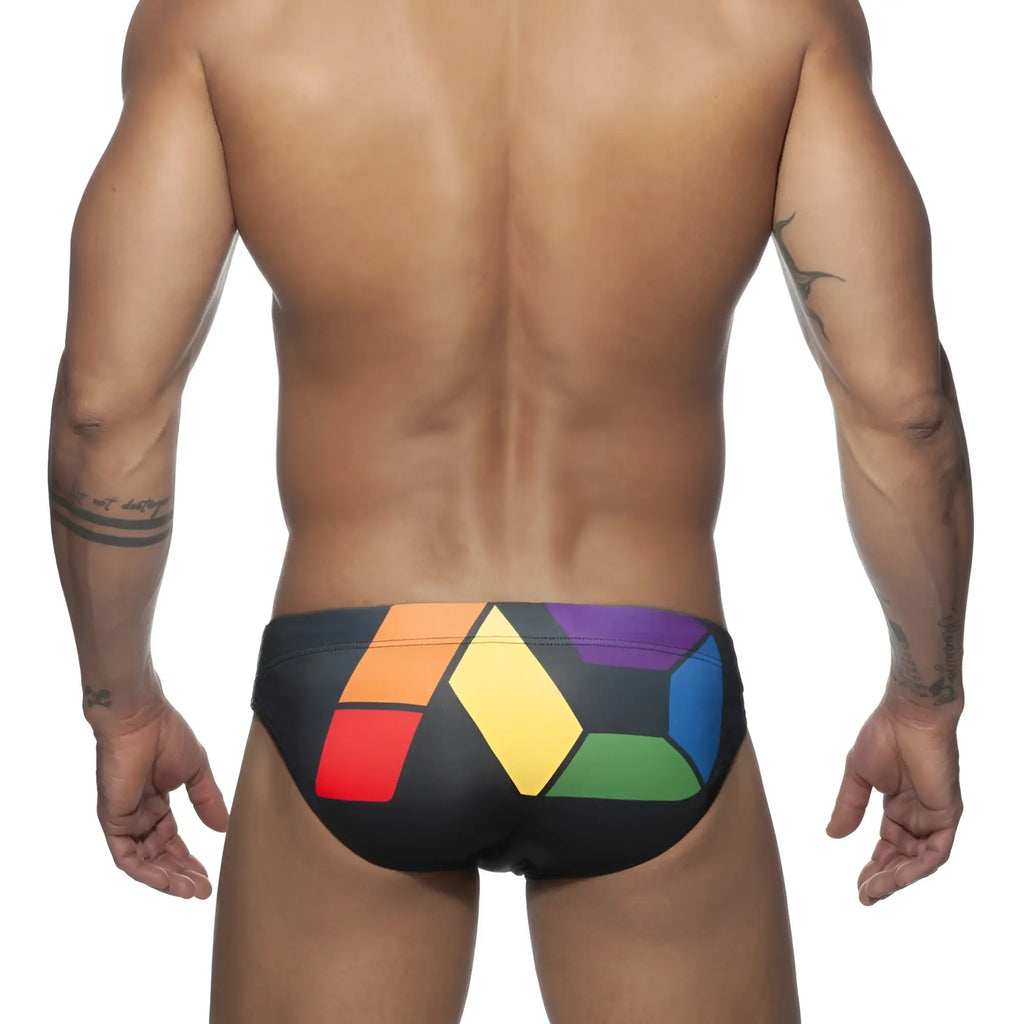 Black ad pride bikini swim trunks with bold geometric rainbow pattern in red orange yellow green blue and purple blocks