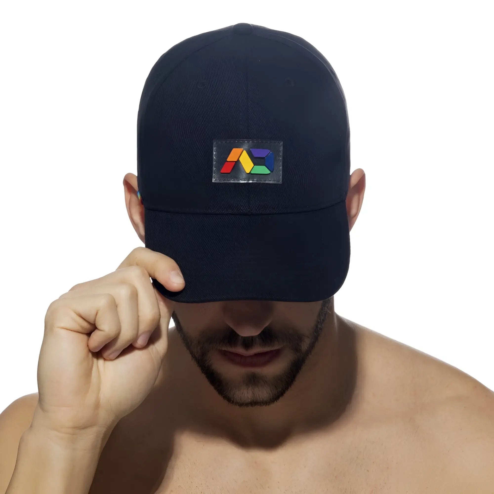 Black baseball cap with a colorful geometric logo patch on the front from the AD rainbow cap collection