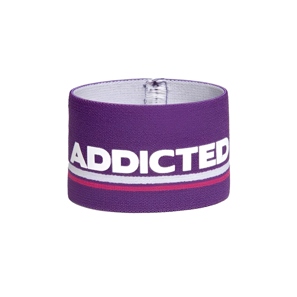Purple elastic wristband bracelet with bold white addicted lettering and a thin red stripe size one size