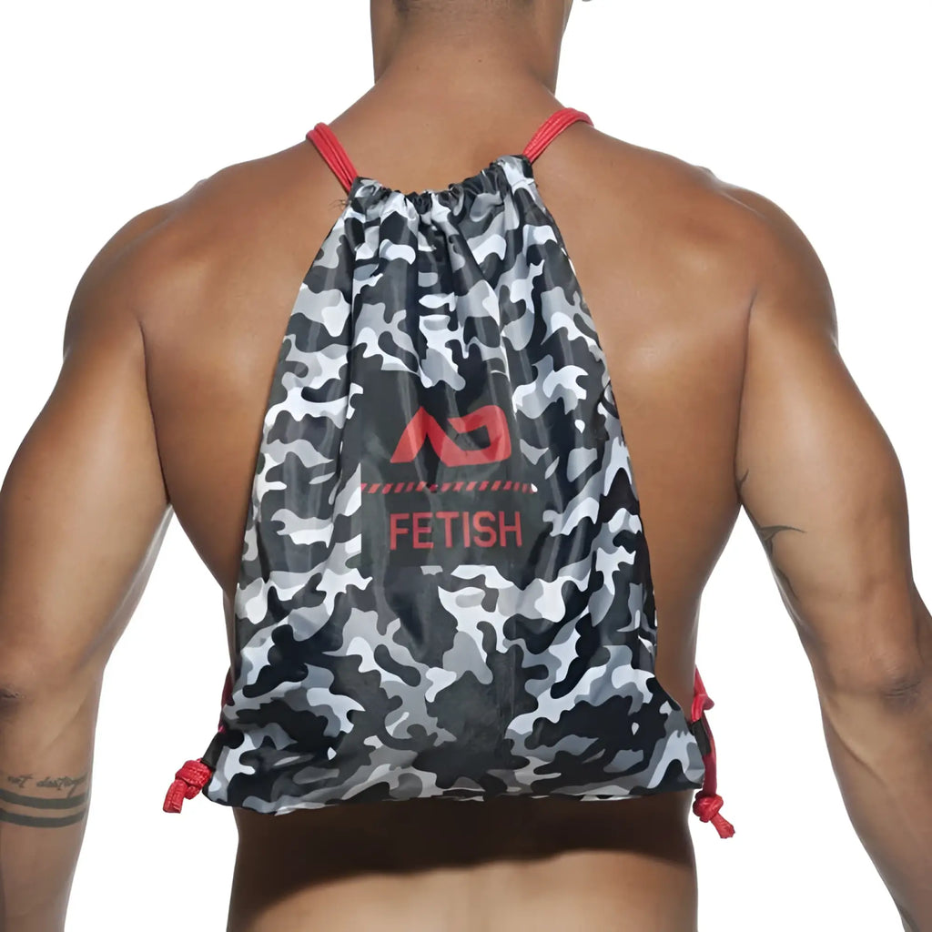 Gray and black camouflage drawstring backpack bag with red trim and bold red fetish logo in charcoal color one size
