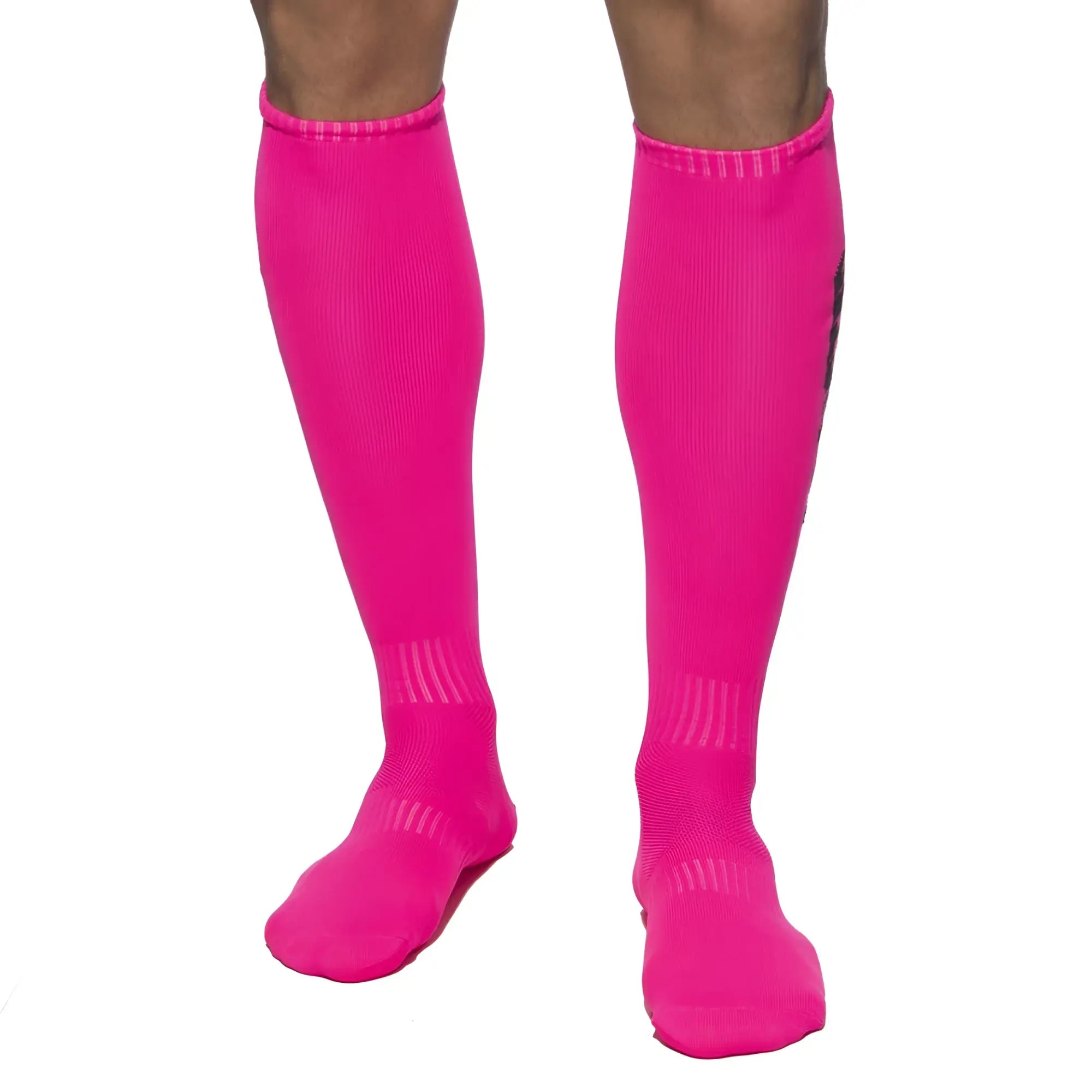 Bright pink ADDICTED neon athletic knee-high socks with ribbed texture and subtle black branding on the side