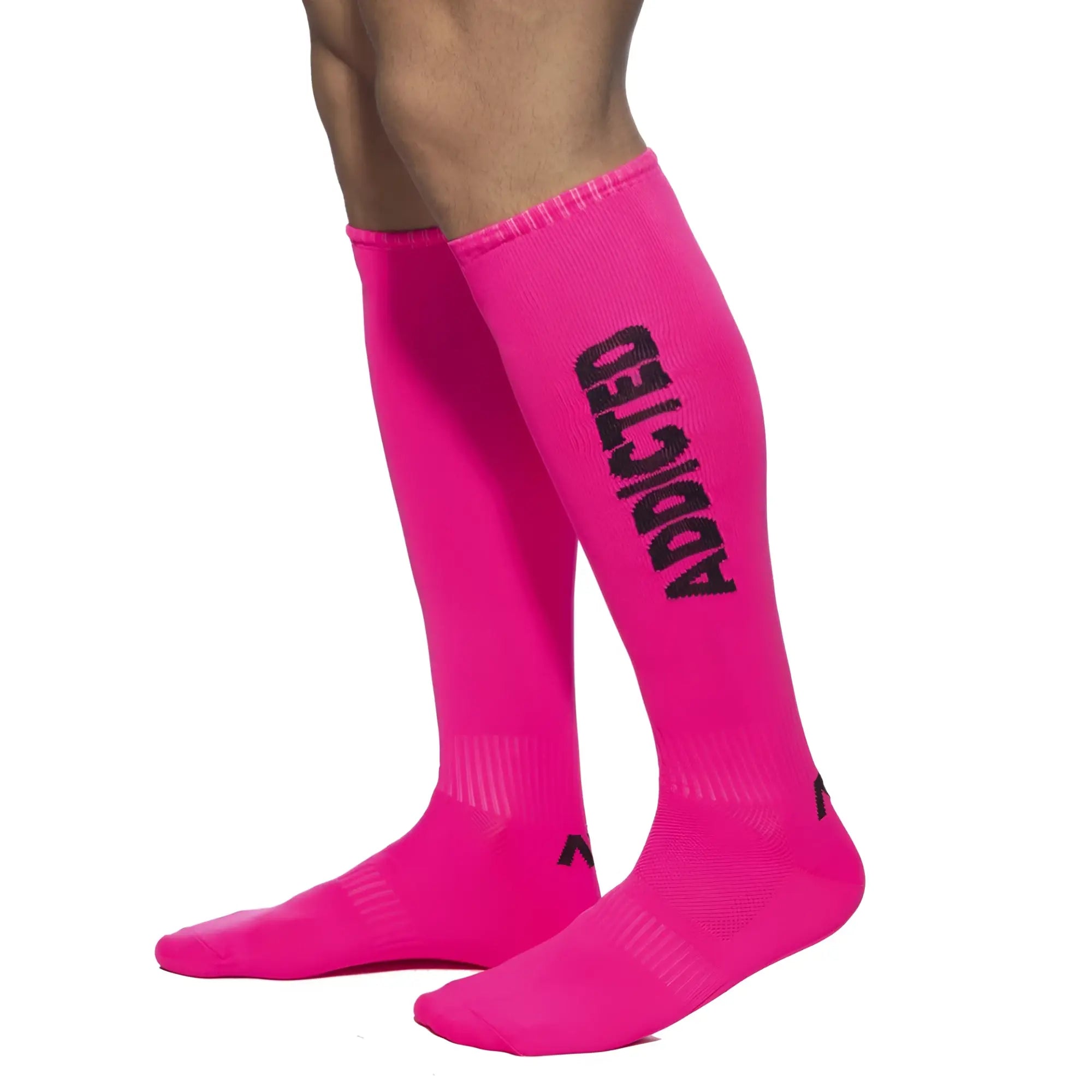 Bright pink knee-high neon socks with bold black addicted lettering down the side for a trendy statement look