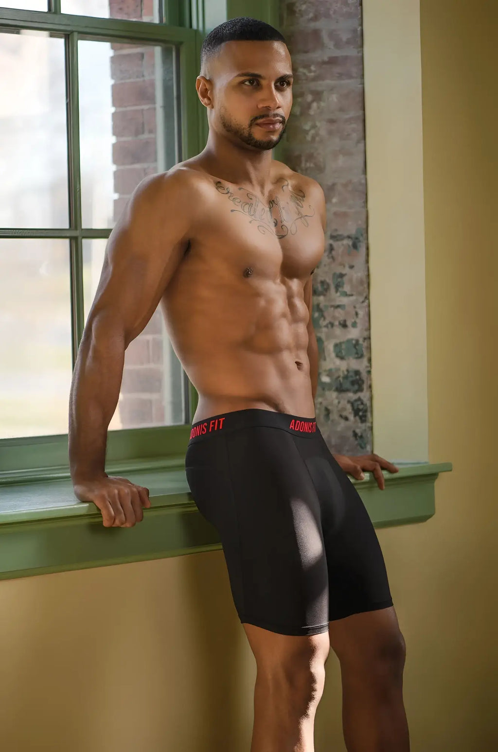 Adonis fit performance long black boxer brief compression shorts with red adidas branding on the waistband