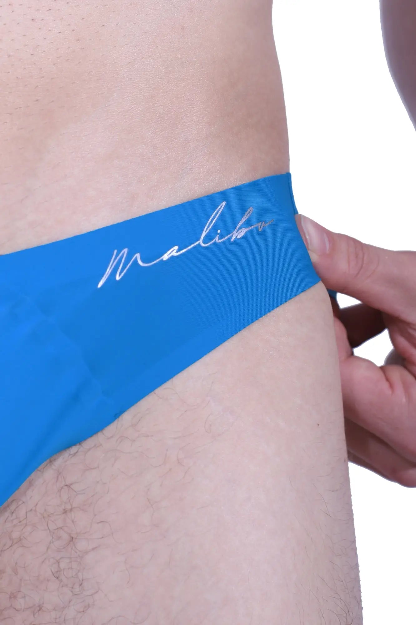 After-hours silky seamless briefs in neon blue with bright blue malibu swim trunks and white cursive logo waistband