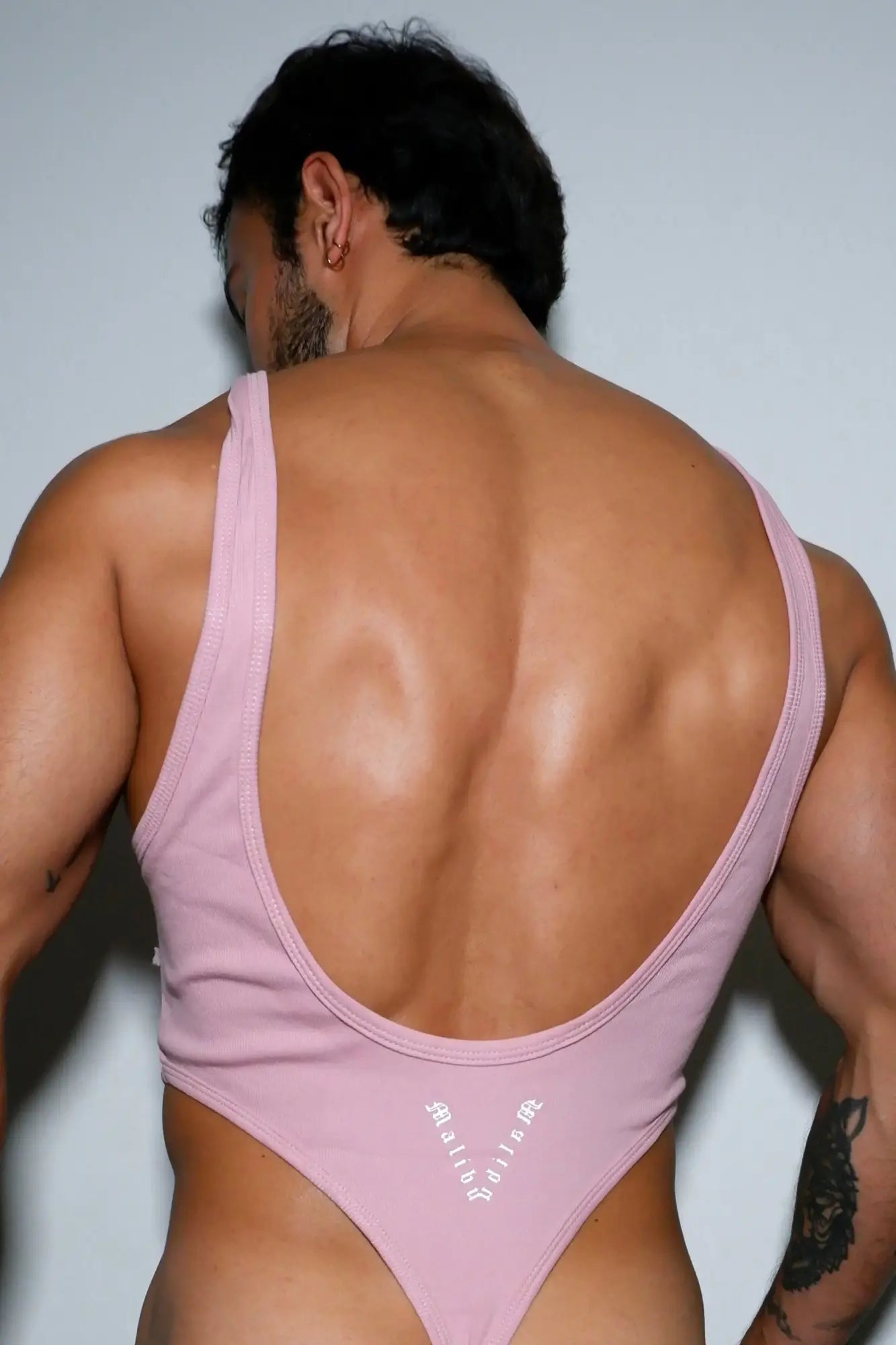 Afterglow ribbed bodysuit blush pink showing back with deep cutout thin straps in form-fitting ribbed fabric