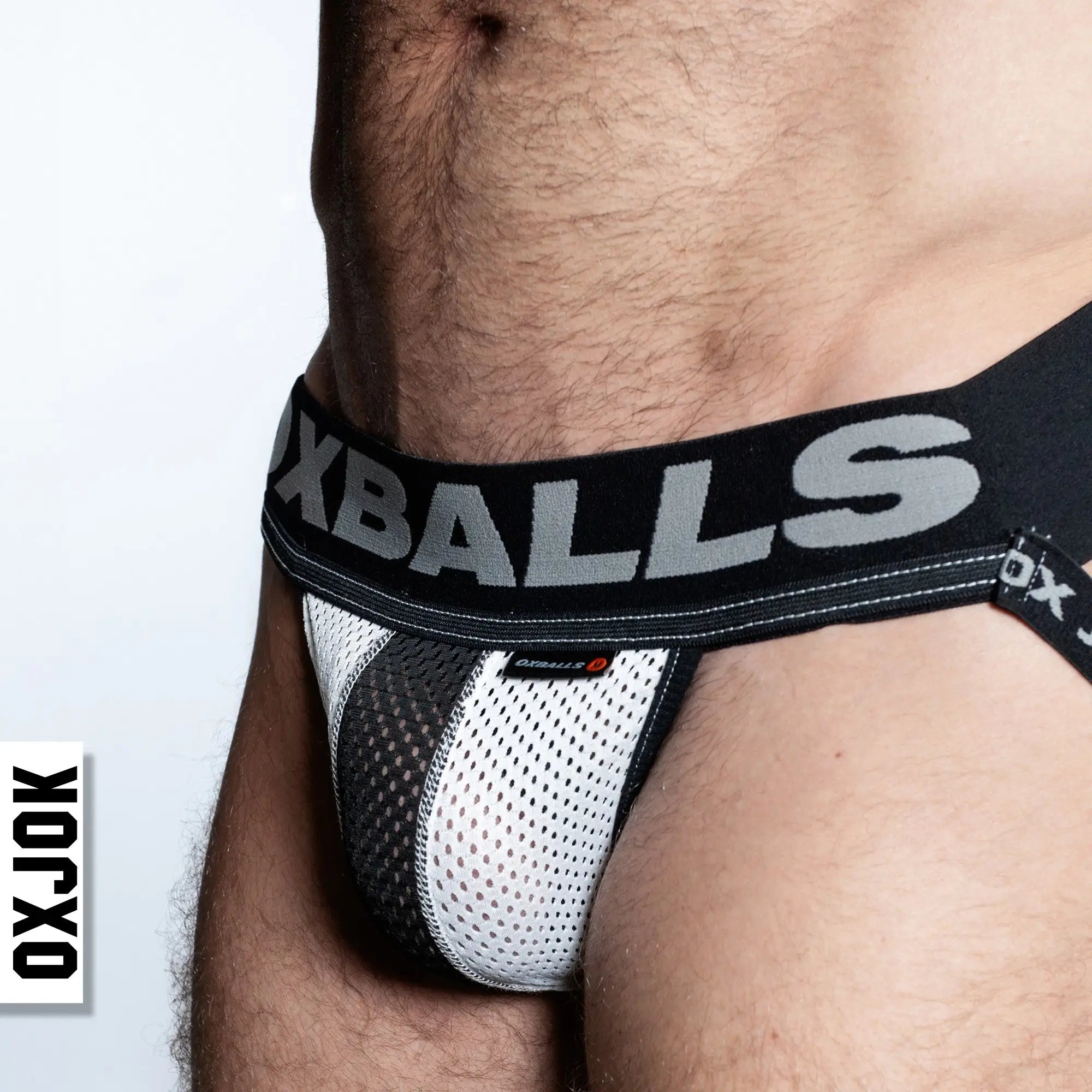 Black and white airmesh jockstrap briefs with mesh material and bold oxballs logo on the waistband