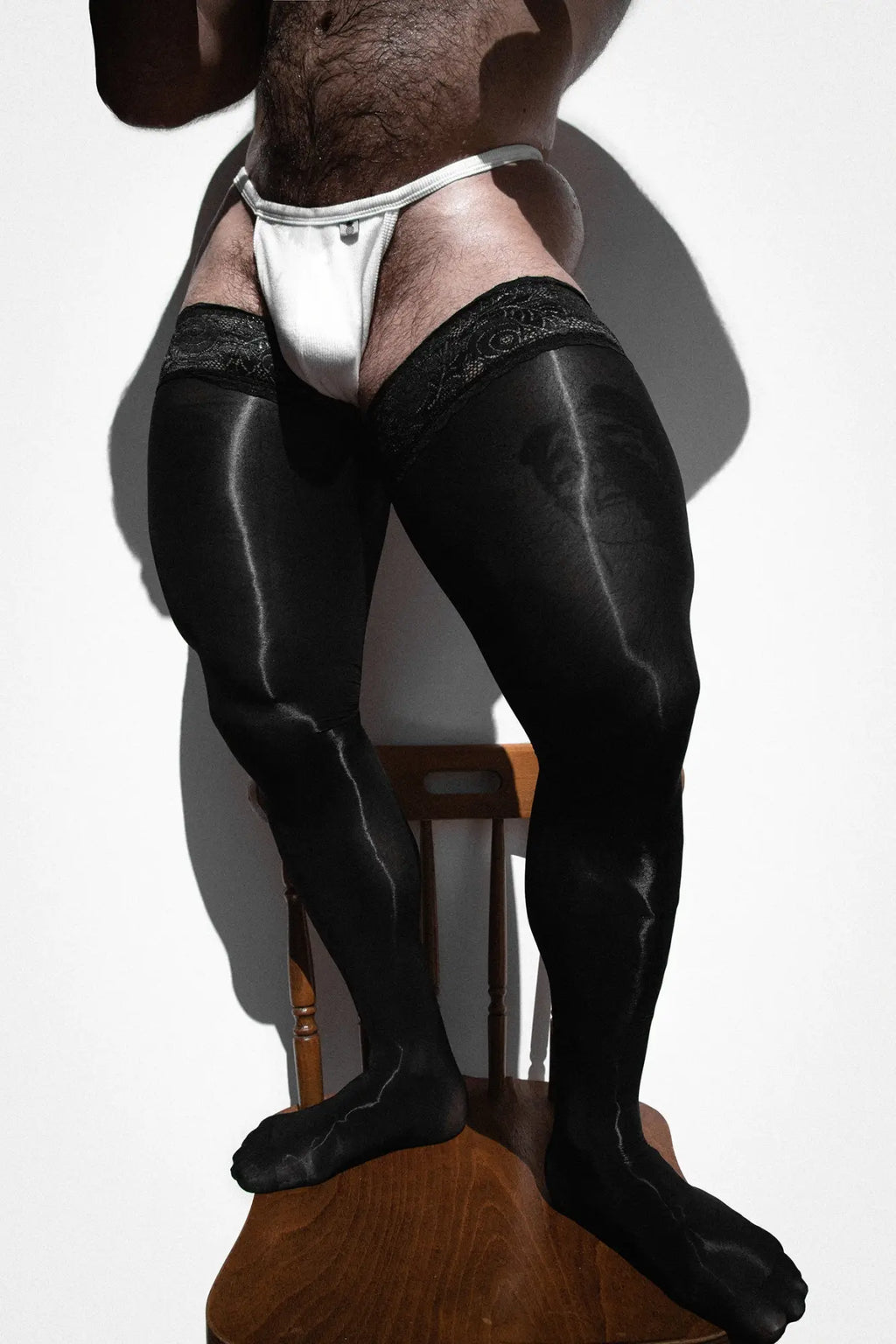 Black satin thigh-high stockings with lace trim from Allure Lace-Top Stockings obsidian collection