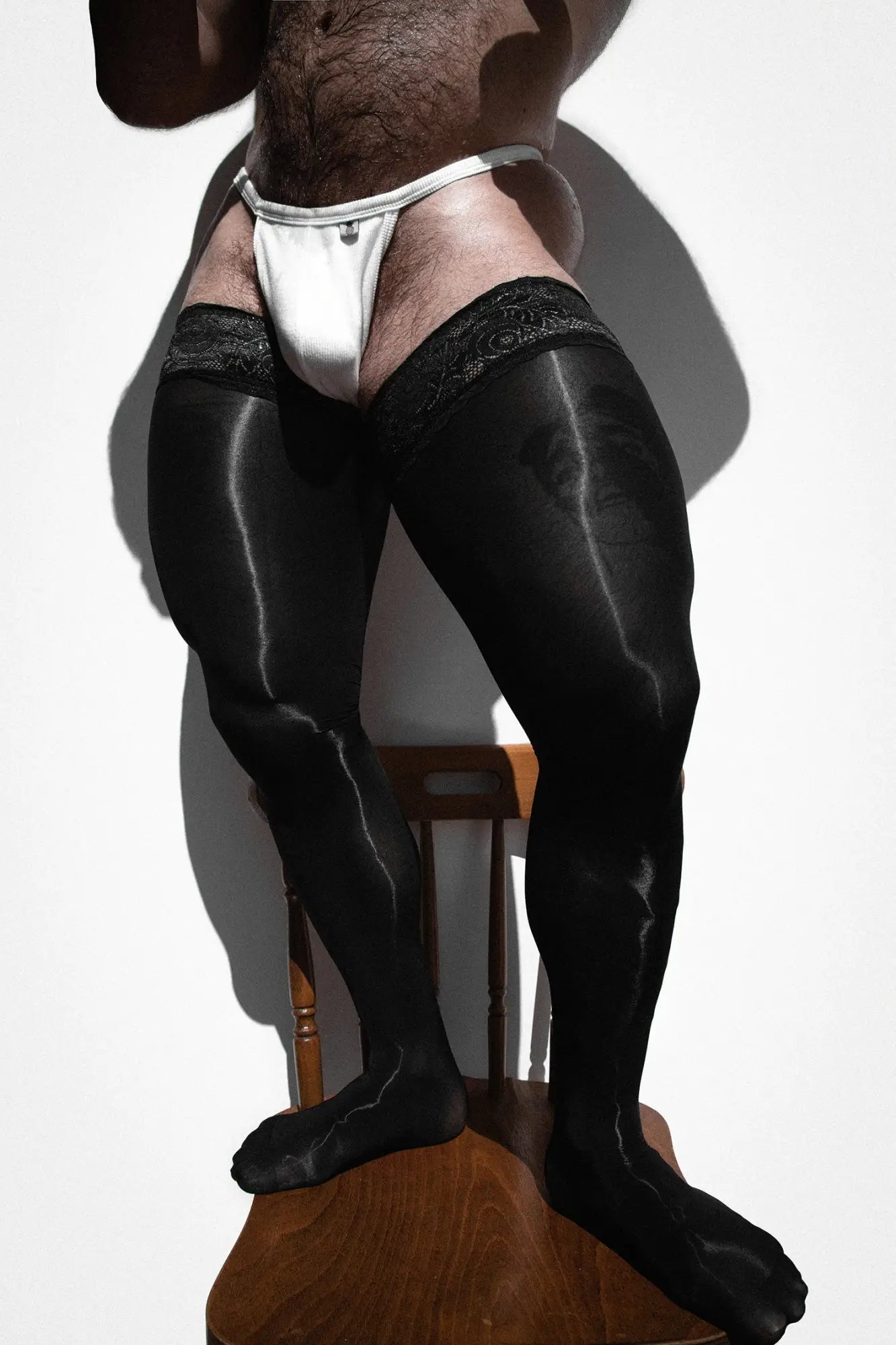 Black satin thigh-high stockings with lace trim from Allure Lace-Top Stockings obsidian collection