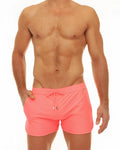 Along slit swim short bright pink swim trunks with drawstring waistband and small logo on front for casual beachwear