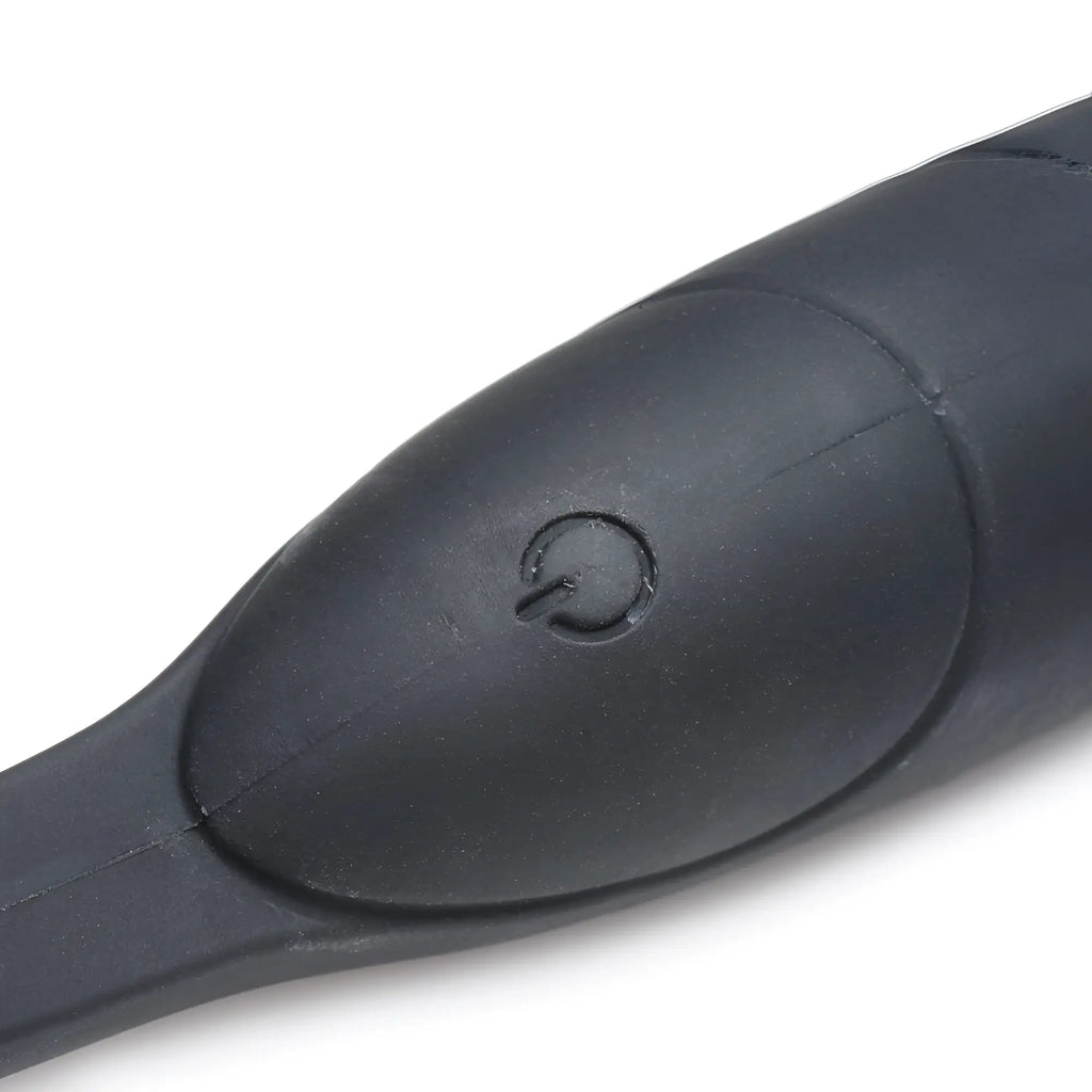 Close-up of the black silicone Alpha Pro 10X P-Bomb featuring a tactile power button on its smooth, contoured surface.