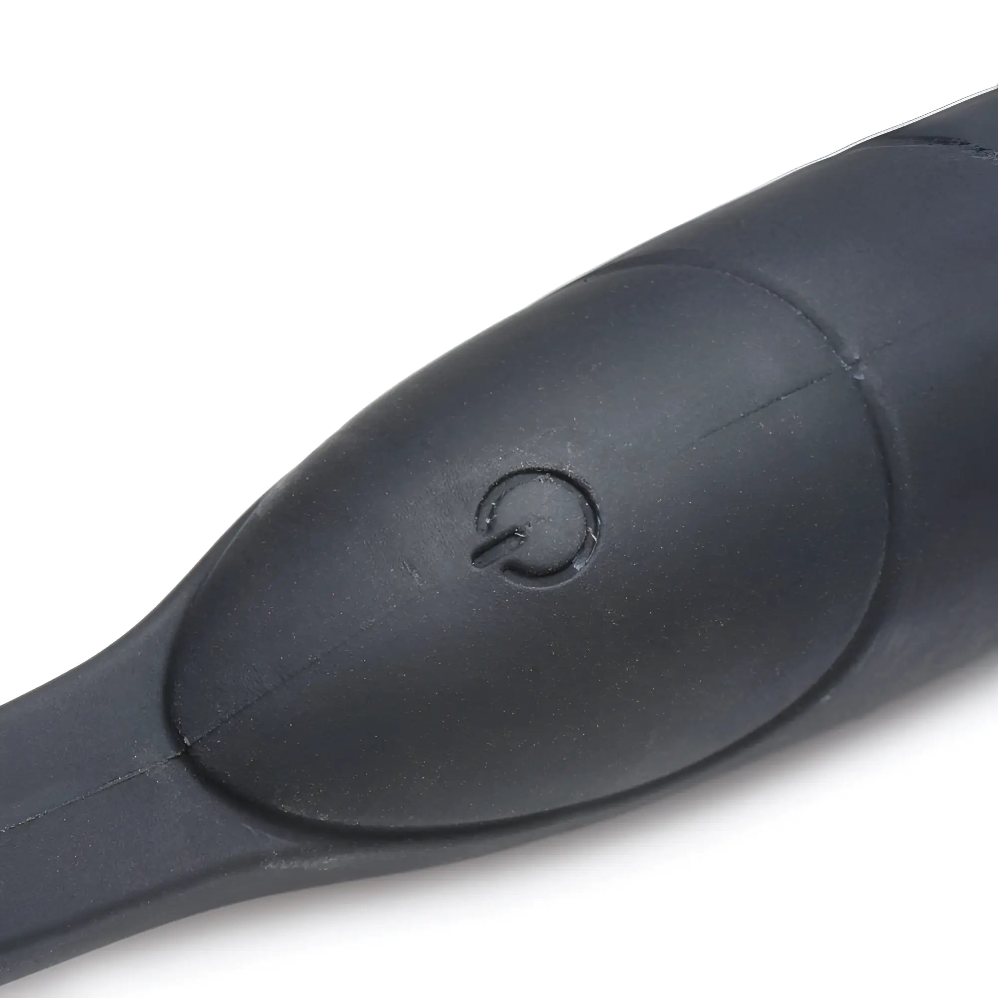 Close-up of the black silicone Alpha Pro 10X P-Bomb featuring a tactile power button on its smooth, contoured surface.
