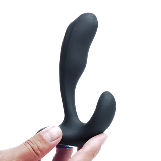 Alpha Pro 7X black, bendable prostate stimulator with curved, ergonomic design held by a hand against a white background.
