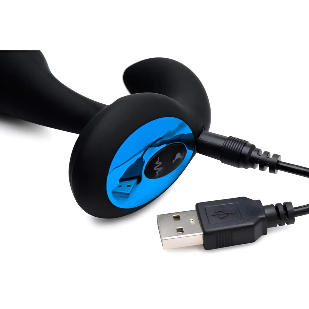 Alpha Pro 7X prostate stimulator: black, curved silicone device connected to a USB charging cable on a white background.