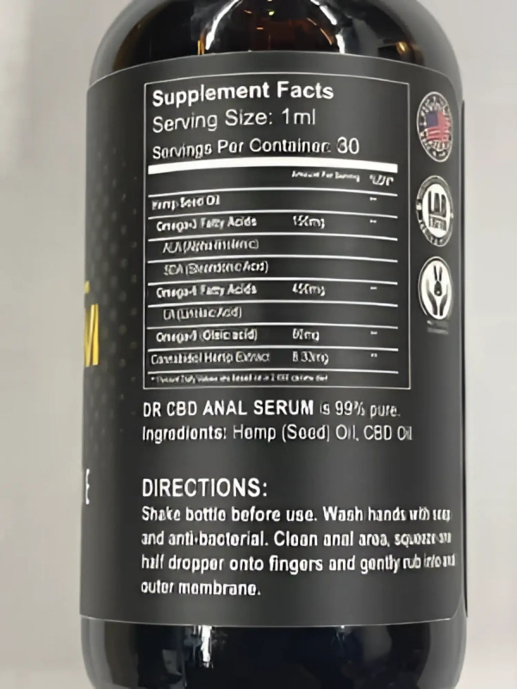 Dark amber glass bottle of dr cbd anal serum with black label white text and american flag emblem containing 95 hemp seed oil