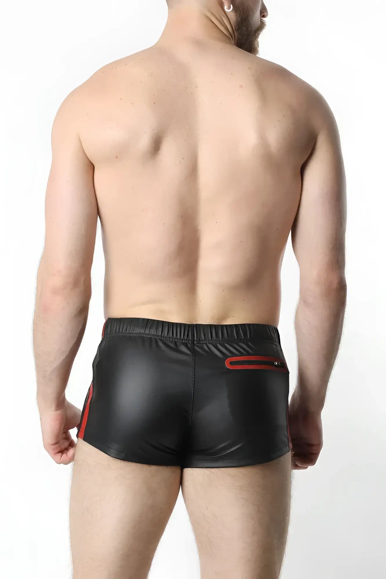 Black shiny faux leather anti-chrome gear shorts with red side stripes and a red zipper pocket on the back view