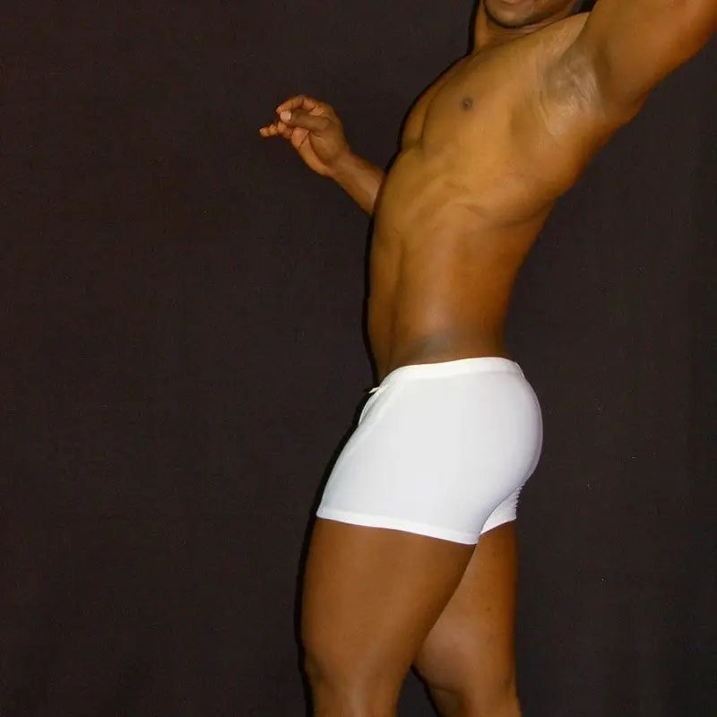 White squarecut swim boxers by Arroyman featuring a snug fit and smooth fabric shown on a model against a dark background.