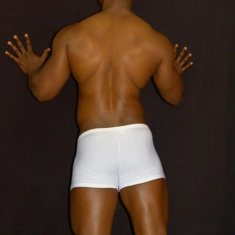 White squarecut swim boxer shorts by Arroyman featuring a snug fit and smooth fabric shown on a model from the back.
