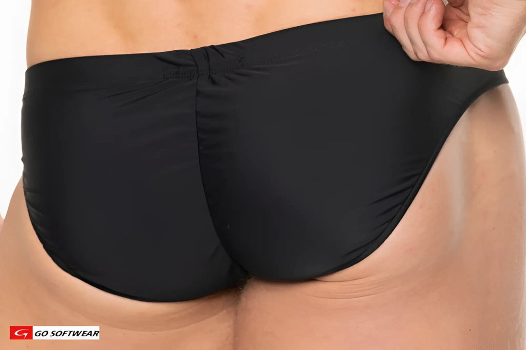 Black Apollo buns bikini swim trunks with smooth stretchy fabric and contoured back design shown from the back