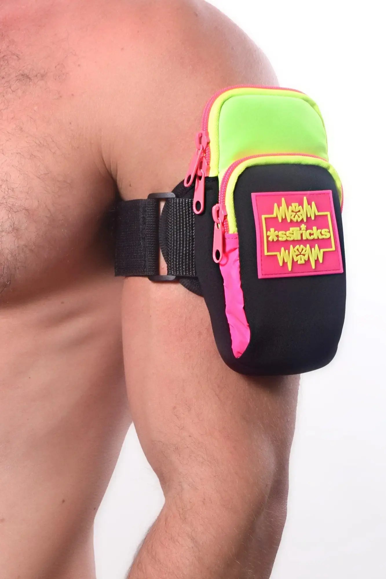 Neon green and pink arm bag with black straps and bold m*sssticks logo patch for athletic use