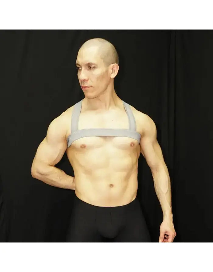 Grey body chest harness made of elastic material worn by a model showcasing a minimalist design by Arroyman.