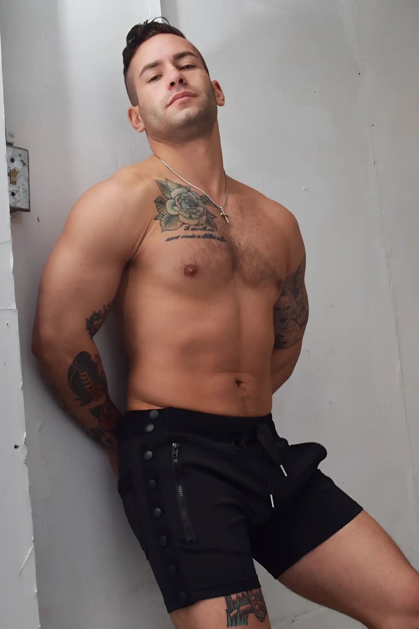 Black backpack shorts with zipper and button details designed for athletic and outdoor use
