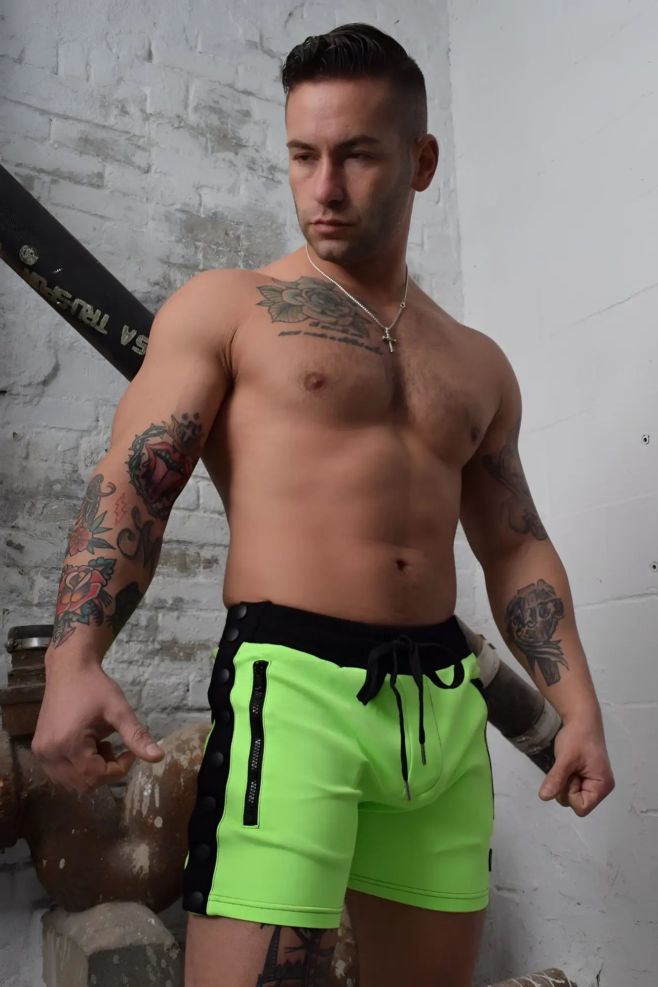 Neon green backpack shorts with black side panels and drawstring waistband designed for athletic use