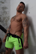 Neon green backpack shorts with black side panels and matching drawstring belt for athletic wear