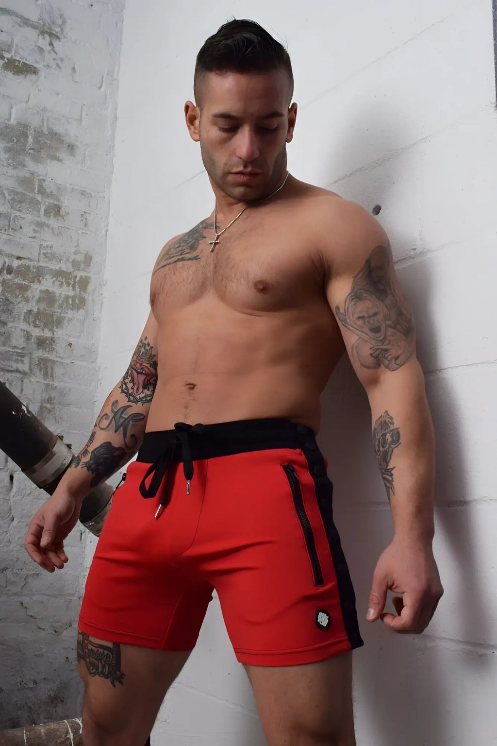 Red backpack shorts with black side panels drawstring waistband and zipper pockets for athletic use