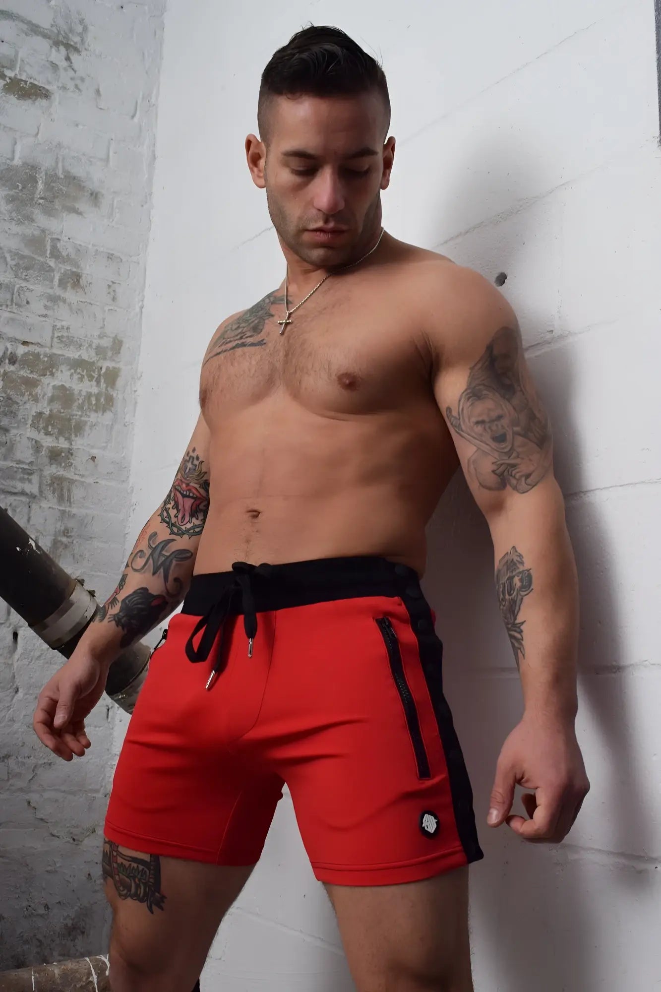 Red backpack shorts with black side panels drawstring waistband and zipper pockets for athletic use