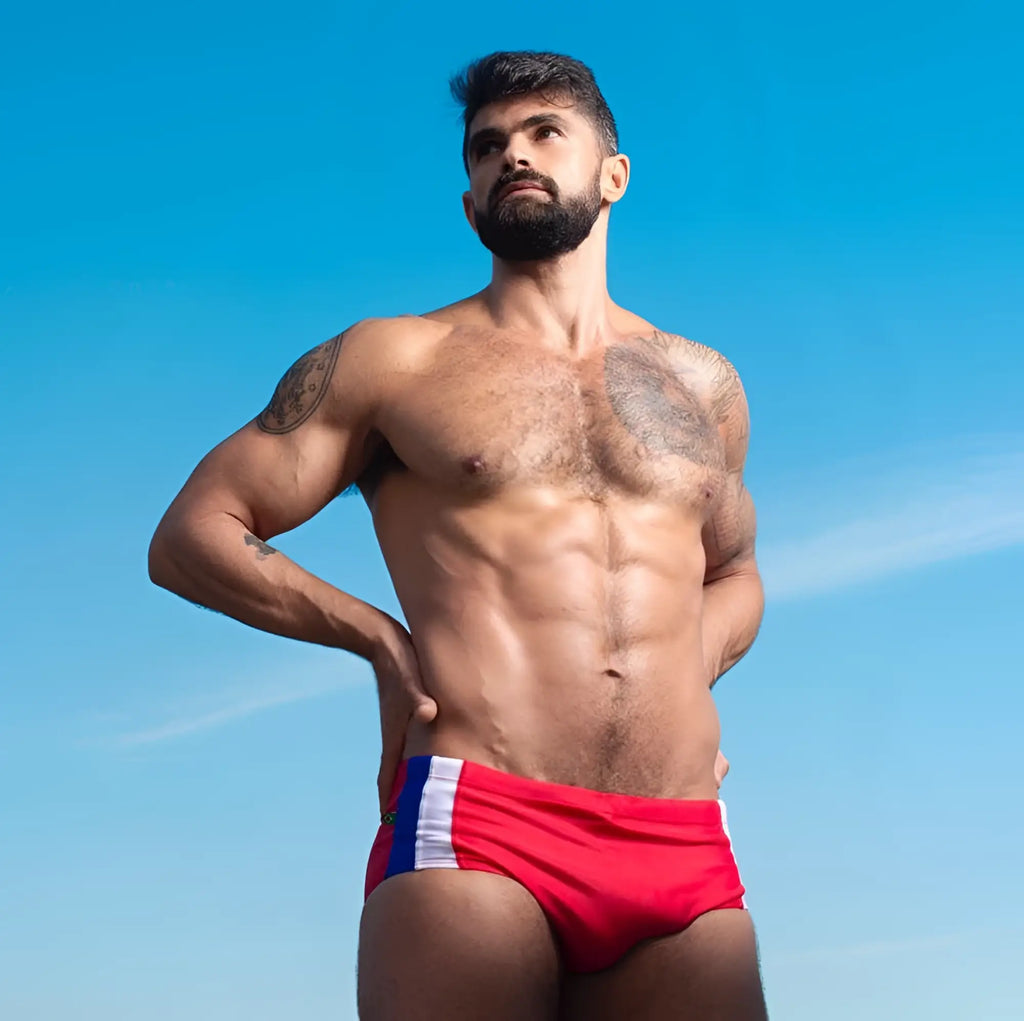 Red swim trunks Bahia Trio Sunga in classic cut with white and blue side stripes designed as designer swim shorts