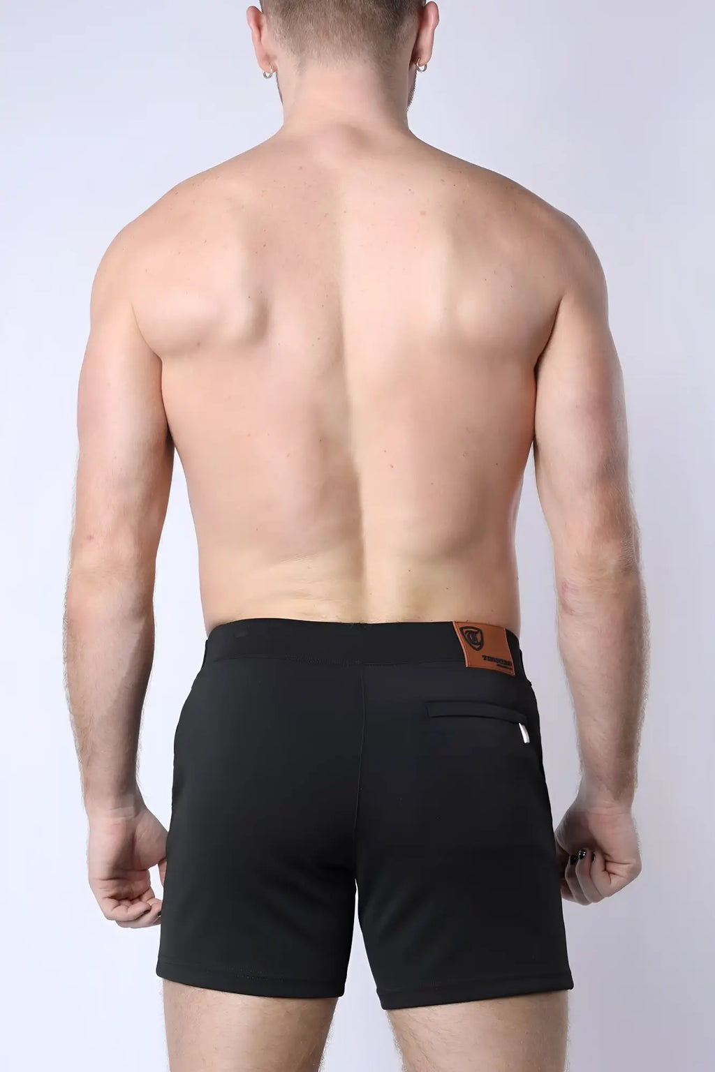 Black balboa hybrid swim shorts with a brown leather patch on the waistband showing the back side