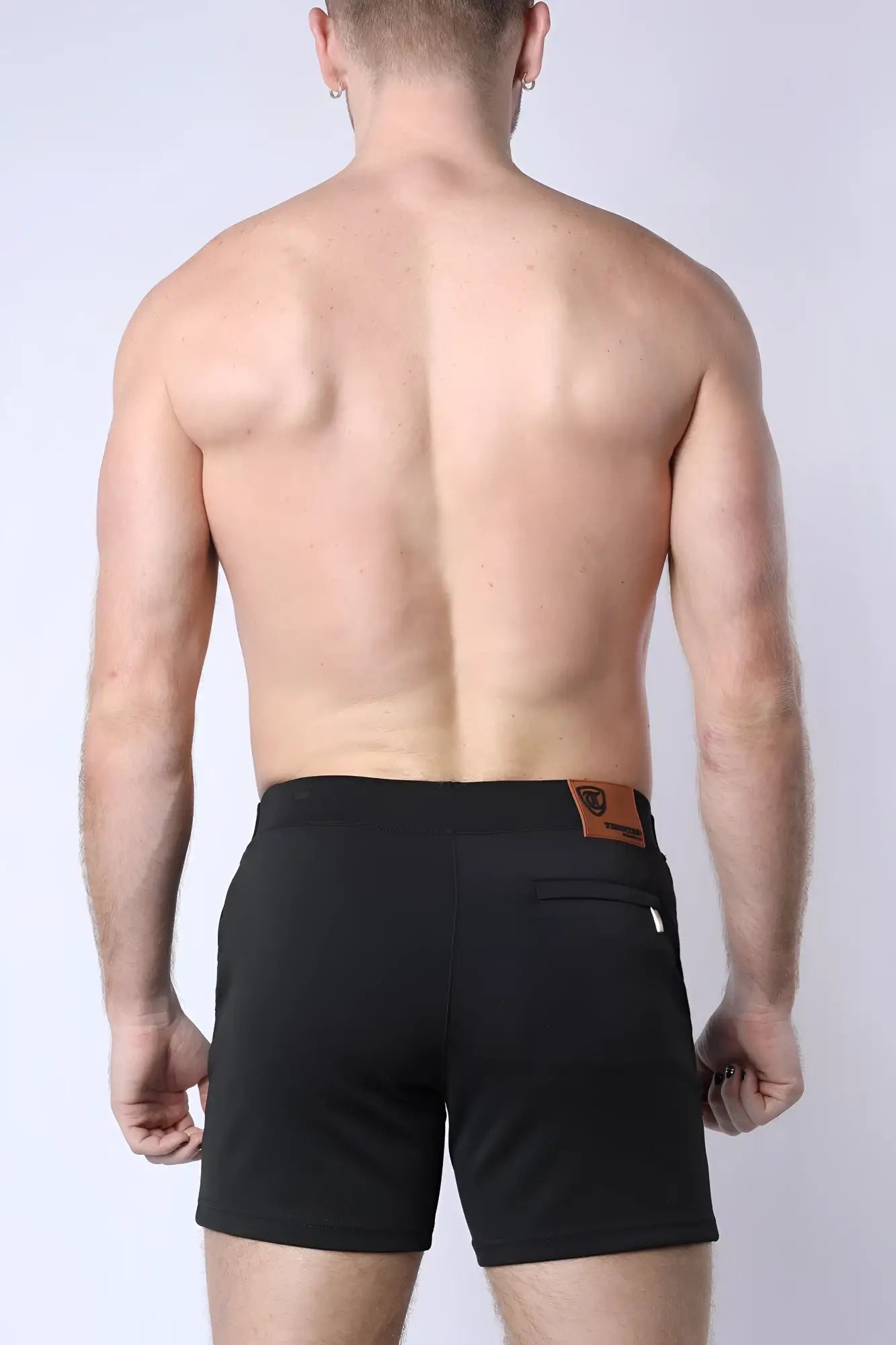 Black balboa hybrid swim shorts with a brown leather patch on the waistband showing the back side