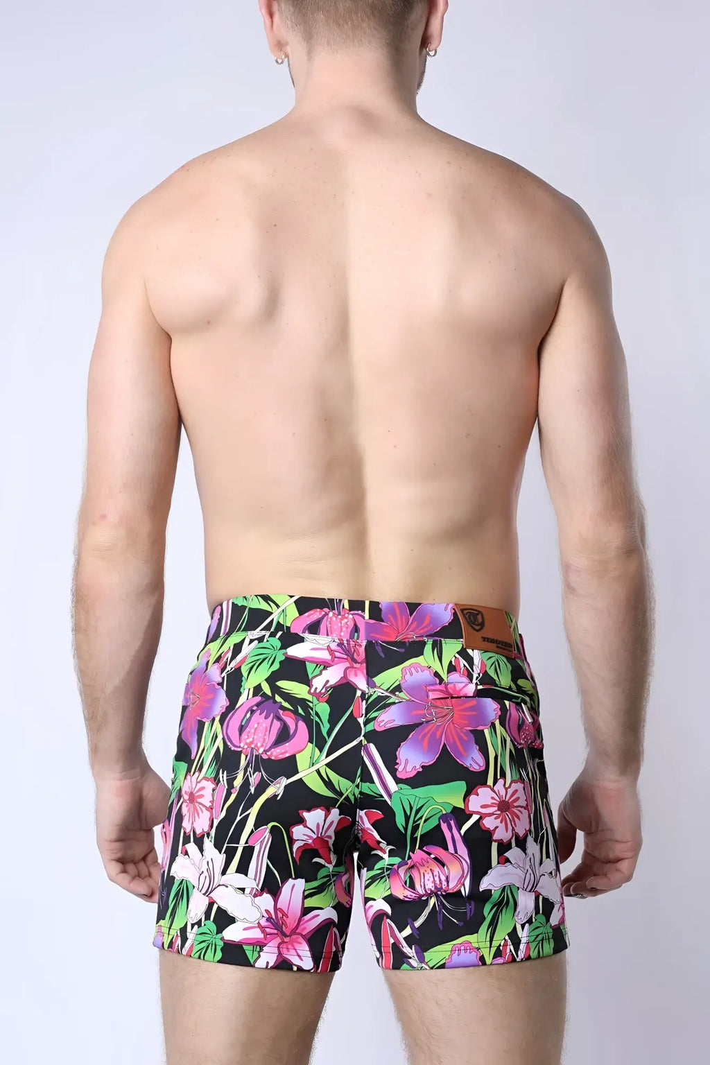 Balboa hybrid swim short vibrant floral patterned swim trunks in pink purple and green hues on black background