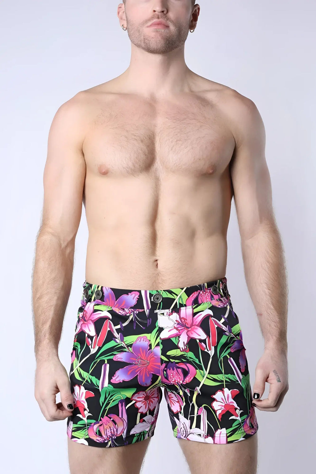 Balboa hybrid swim short featuring vibrant floral pattern in bold pink purple and green hues on black background