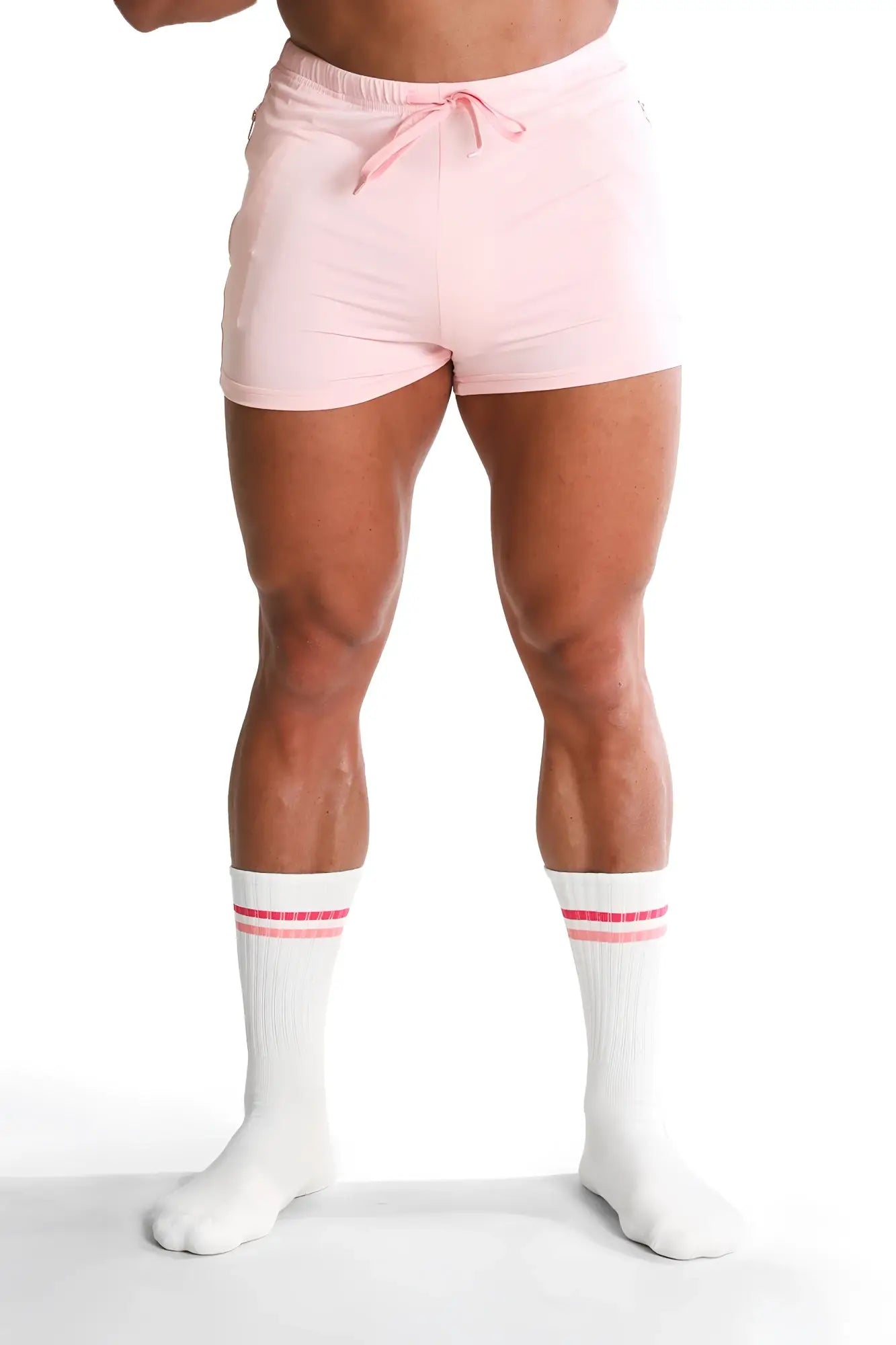 Pink athletic shorts with drawstring waistband and subtle side pockets paired with banded high socks strawberry stripes