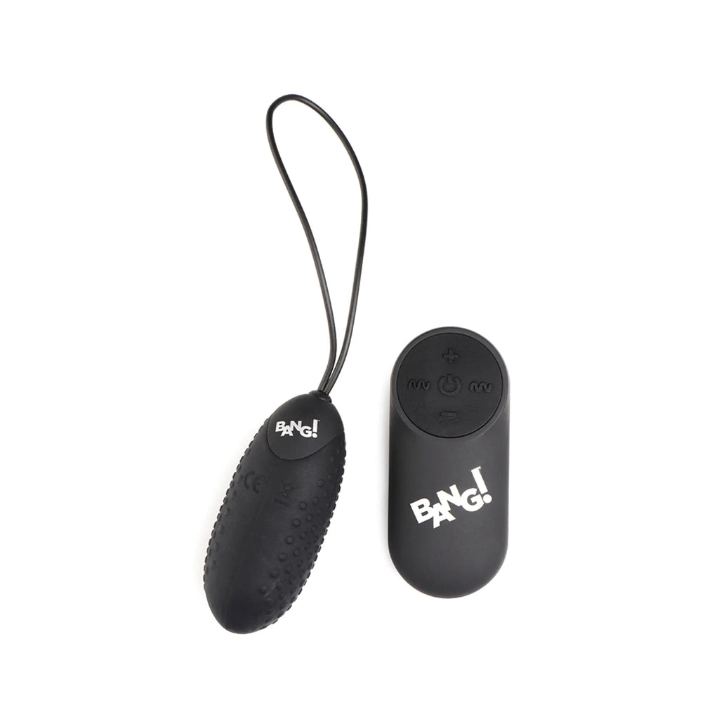 Black Bang 28X nubbed silicone vibrating egg with a pull cord and a matching remote control on a white background.